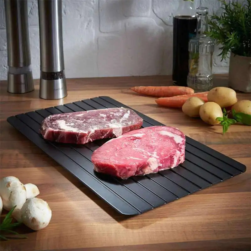 steak pieces on the rapid meat defrosting tray