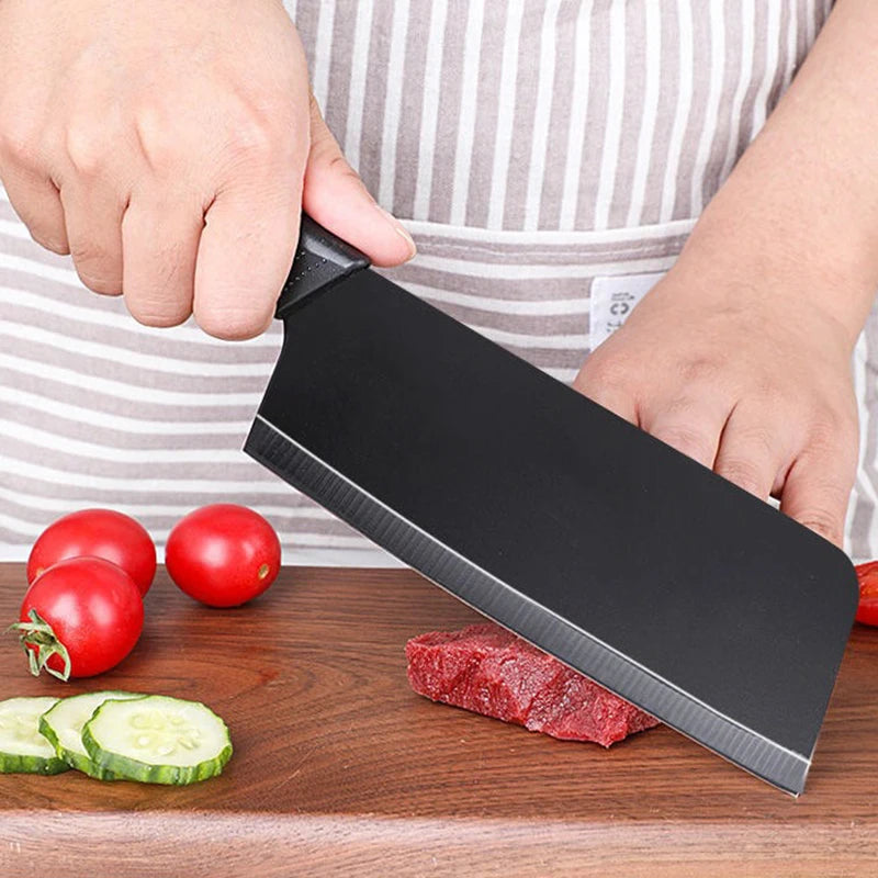 Knife slicing vegetables on a wooden cutting board