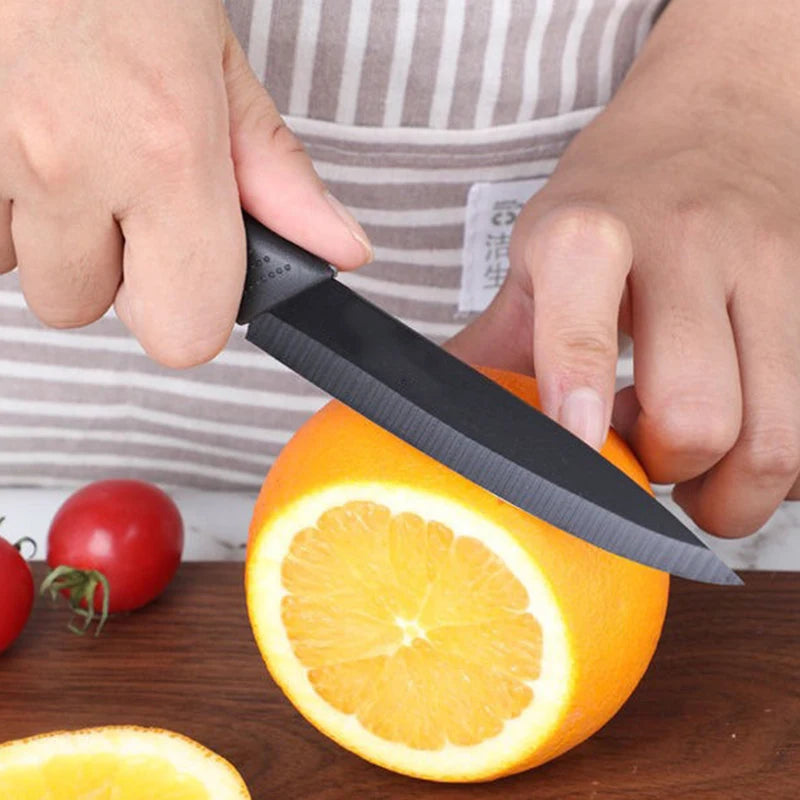 Knife slicing fruits on a wooden cutting board