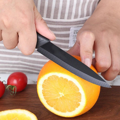 Knife slicing fruits on a wooden cutting board
