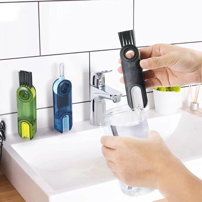 brush cleaning glass in sink