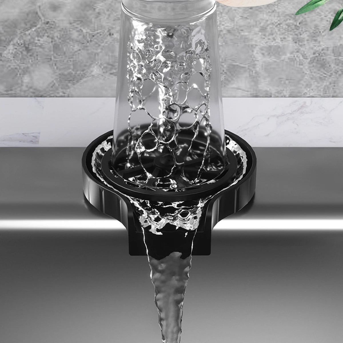Clear glass being filled with water from a black faucet against a gray marble background
