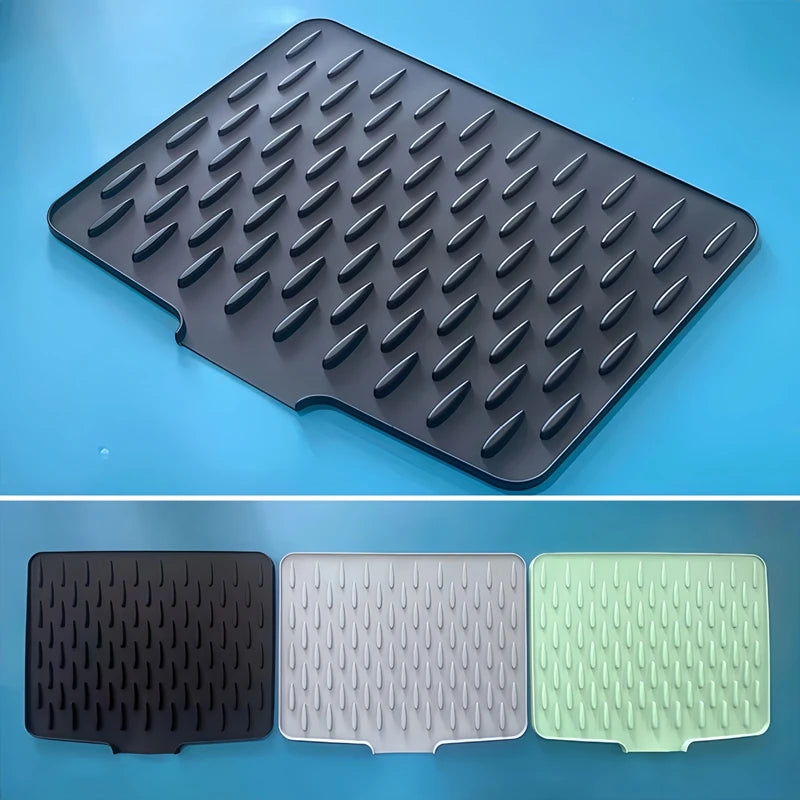 Black textured silicon drying mat on a blue background with additional mats in black, white, and green shown below.